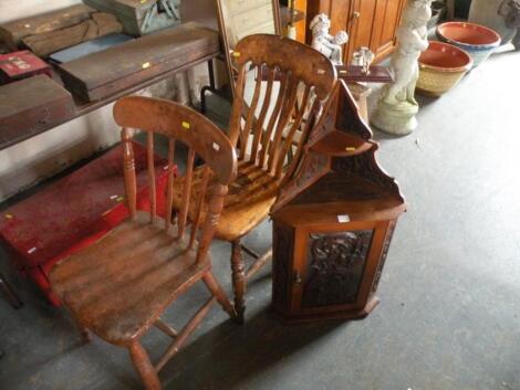 A late Victorian carved walnut hanging corner cabinet