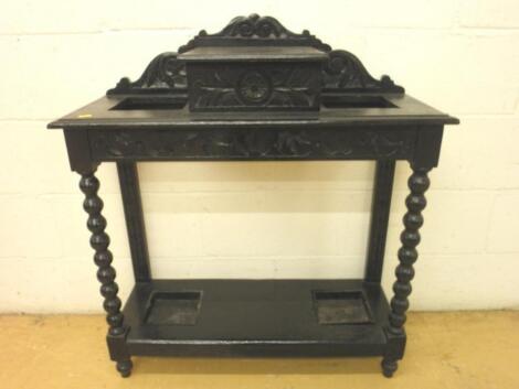 A carved oak hall stand on spirally turned legs