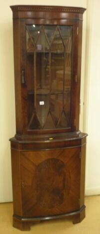 A mahogany standing corner cabinet