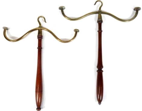 A pair of brass and turned mahogany wig stands, each with shaped hook tops and turned handles, 38cm H. (2)