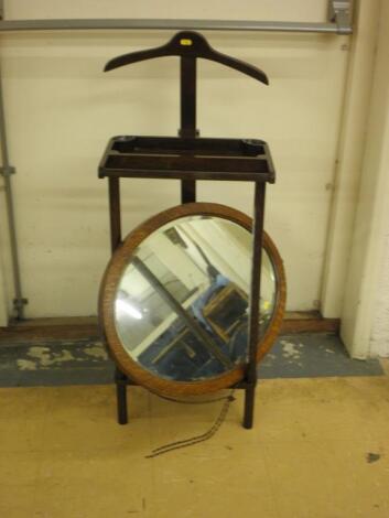 An oak gentleman's jacket stand and an oval mirror