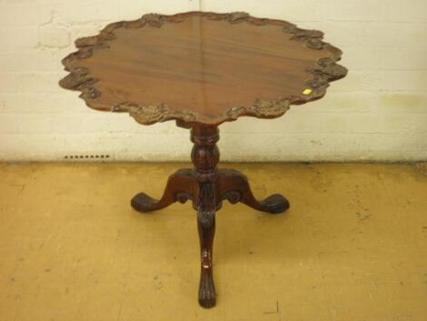 A mahogany occasional table with a pie crust top