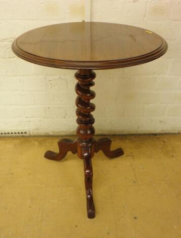 A Victorian mahogany occasional table on a spirally turned column