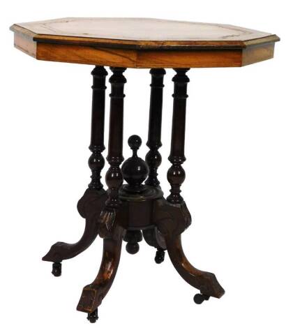 An Edwardian walnut occasional table, the octagonal top with a wide crossbanding, raised on quadruple supports terminating in inverted legs heavily carved with floral ends terminating in castors, 68cm H, 64cm W, 64cm D.