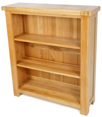 A light oak finish Wren open bookcase, of rectangular form, on stiles, 110cm H, 98cm W, 31cm D.