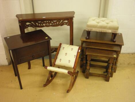 A modern hardwood side table with a pierced frieze