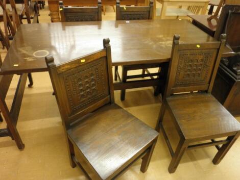 An oak refectory type table on end supports and four dining chairs