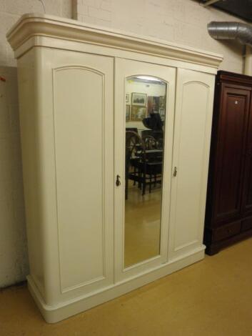 A Victorian triple wardrobe with a single mirror door flanked by two further