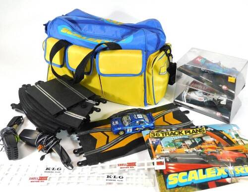 A Scalextric bag, 45cm W, containing a quantity of various track, other accessories, cars, etc. Inco Stewart-Ford racing car, etc. (a quantity)