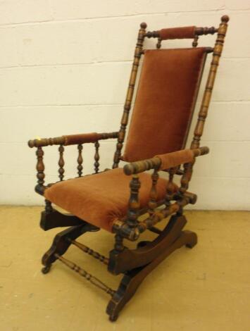 A Victorian turned wood rocking chair with a padded back