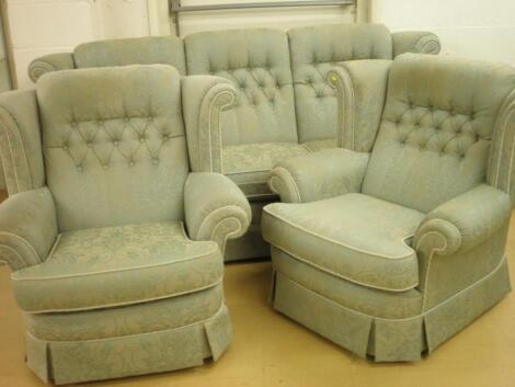 A three piece suite upholstered in pale green and dark green