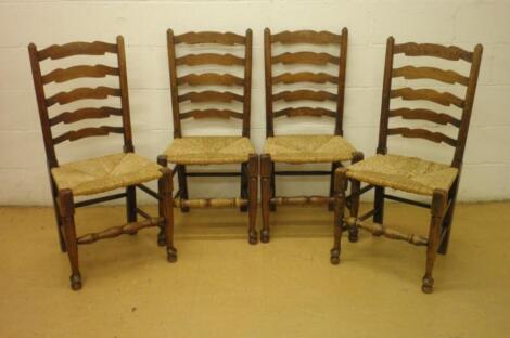 A set of four oak ladderback dining chairs