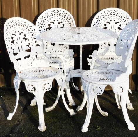 A late 20thC metal framed patio suite, comprising white metal table of circular form, with partially pierced centre, on triple scroll legs, 69cm H, 72cm Dia. and four shell backed chairs with pierced circular seats, on sabre legs. (5)