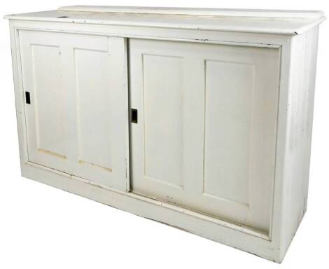 A late 19thC pine cupboard, of rectangular form, with articulated front doors, painted white, 112cm H, 182cm W, 62cm D.