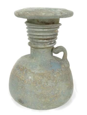 A Roman glass vessel, possibly a lamp, of turned form, on shaped base, 11cm H.