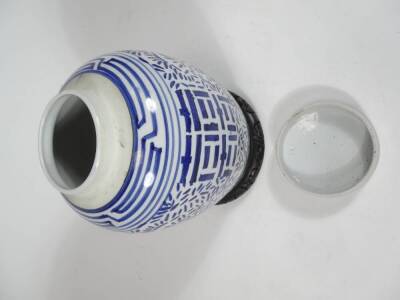 A Chinese pottery Ming style jar and cover, in a geometric pattern with upper Greek key style banding, 28cm H, unmarked, on an ebonised wooden base. - 2