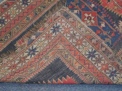 A Caucasian rug, of geometric design with two central medallions, and centre star gul enclosed within repeat borders with stars, blocks and hooks, 152cm x 112cm. (AF) Auctioneers Note: Rug has live moth, and all are as found. Viewing is strongly recommen - 3