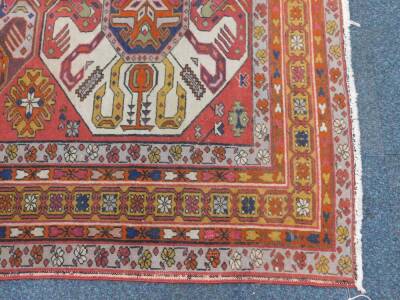 An Azerbaijan Kazak rug, with three central medallions on a red ground, enclosed by triple borders with flowers and guls, 206cm x 142cm. - 3