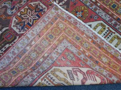 An Azerbaijan Kazak rug, with three central medallions on a red ground, enclosed by triple borders with flowers and guls, 206cm x 142cm. - 4