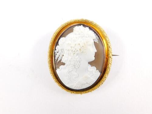 A Victorian oval cameo brooch, set in yellow metal, bust portrait of a lady with vines in her hair, hair locket back, 57mm H, 48mm W.