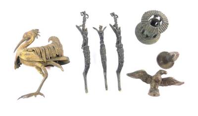 A late 19thC Continental ormolu figure of a heron, modelled in standing pose, (AF), a metal lid with cast dove finial, a brass figure of an eagle with it's wings extended, three furniture mounts, and a copper candle holder modelled as a Greek temple, 4.5c