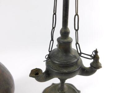 A 19thC brass oil lamp, of Roman oil lamp form, with long carrying handle, the body with three apertures, raised on a serpentine circular base, 48cm H, together with a Middle Eastern metal ewer, engraved with panels of birds, floral emblems and foliate sc - 5