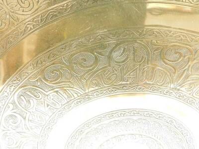 An early 20thC Middle Eastern brass tray table top, engraved with bands of foliate scrolls and script, 57cm Dia. - 2