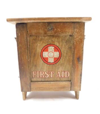 A Cuxson Gerrard & Company Ltd pine first aid cabinet, with a drop down front, opening to reveal two shelves, contents card within but no contents, 32cm H, 27.5cm W, 17.5cm D.