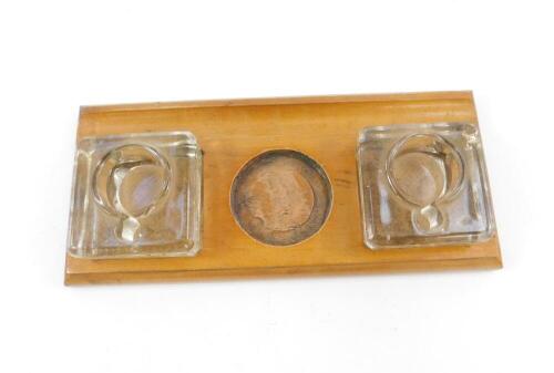 An early 20thC Underwood wooden desk stand, with two moulded glass ink wells, covers lacking, 30cm W.