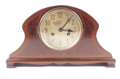 An Edwardian mahogany and bird's eye maple mantel clock, silver circular dial bearing Arabic numerals, Continental eight day movement with coil strike, the case of elongated balloon form, raised on a rectangular base and bracket feet, 23cm H, 41cm W, 13cm