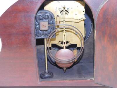 An Edwardian mahogany and bird's eye maple mantel clock, silver circular dial bearing Arabic numerals, Continental eight day movement with coil strike, the case of elongated balloon form, raised on a rectangular base and bracket feet, 23cm H, 41cm W, 13cm - 3