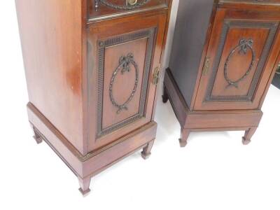 A pair of Adams style Edwardian mahogany side dining pedestals, each with a drawer carved with harebell swags, one with fitted interior, above a panelled door, having a harebell and bow tied wreath, within a fluted surround, opening to reveal a single she - 3
