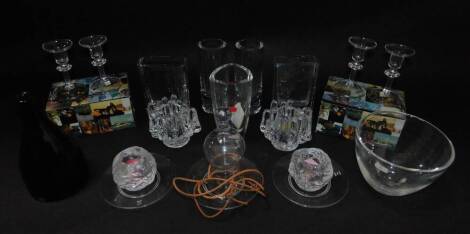 A group of Scandinavian glass, including a pair of Hovamtorp cylindrical glass vases, Lindshammar green glass bottle, Houmanthorp ceiling candle light, a pair of Kosta Boda polar candle holders, and a pair of Crystal Votive candle holders. (qty)