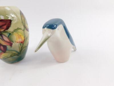 Two Alton porcelain figures modelled as Cinderella and The Mad Hatter, Beswick figure of a penguin with an orange umbrella, Royal Dux porcelain figure modelled as a kingfisher, and a Moorcroft pottery vase of ovoid form decorated with flowers, impressed m - 3