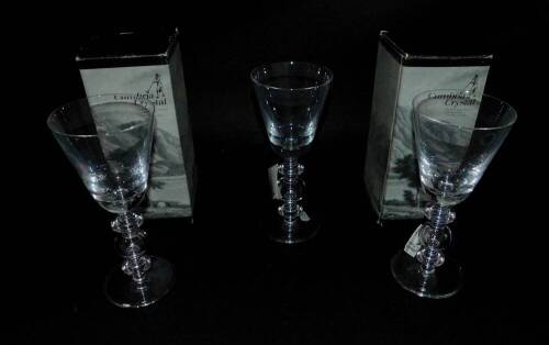 Three Cumbria crystal goblets, the bucket shaped bowl raised on a triple knop stem over a conical foot, two boxed, 22.5cm H.