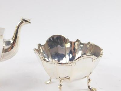 A George V silver three piece tea set, of fluted form, raised on four cabriole legs, comprising teapot, cream jug and sugar bowl, Birmingham 1912, 17.60oz. - 3
