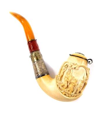 A late 19thC Continental meerschaum pipe, carved in high relief with Bacchus and Putto, with a hinged lid, white metal ferrules engraved with flowers, faceted red amber ferrule and a yellow amber mouthpiece, cased, 23cm W.