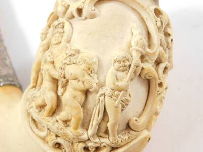 A late 19thC Continental meerschaum pipe, carved in high relief with Bacchus and Putto, with a hinged lid, white metal ferrules engraved with flowers, faceted red amber ferrule and a yellow amber mouthpiece, cased, 23cm W. - 2