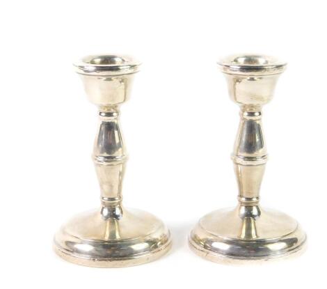 A pair of loaded silver candlesticks, of hour glass form, Birmingham 1959, 10cm H, 7.86oz all in.