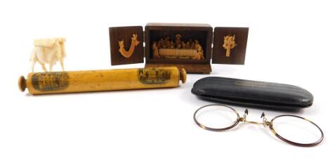 A Victorian mauchline ware miniature rolling pin, printed with views of Wadhem College and Exeter College Oxford, 17.5cm H, an ivory carving of a camel, a pair of horn rimmed pince-nez, and a carved wooden tabernacle opening to reveal The Last Supper and 