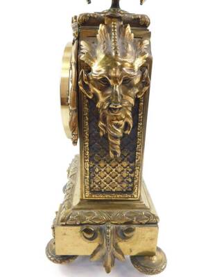 A late 19thC Continental brass mantel clock case, with later dial and Quartz movement, the case cast with an urn with twin ram's head handles, masks and wreaths, musical instruments and flowers, raised on four turned feet, 37cm H. - 5