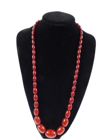 A string of graduated cherry amber beads, fifty three beads, 66.8g.