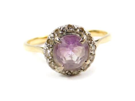 A Victorian amethyst and diamond ring, set with a pale rose cut amethyst, in a surround of diamonds, set in yellow metal, size R, 3.2g.