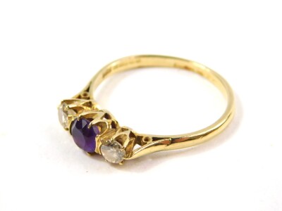 An 18ct gold diamond and amethyst three stone ring, diamonds approx 0.5cts, size R, 3.0g. - 3