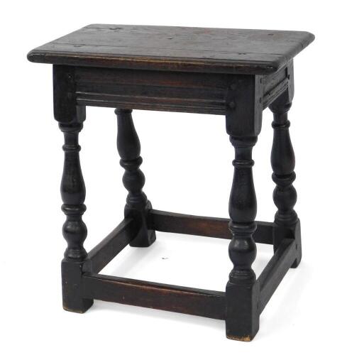 A 17thC style oak joint stool, raised on baluster turned supports united by stretchers.