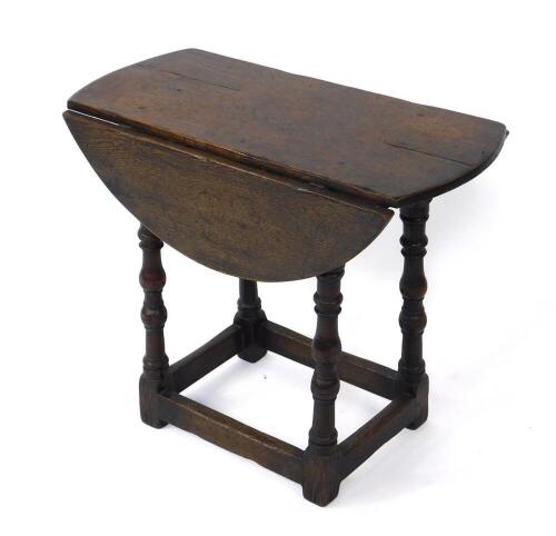 A 17thC style oak drop leaf occasional table, raised on baluster turned supports, united by stretchers, 58cm H, 68cm W, 33cm D, 66cm extended.