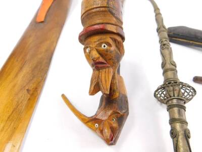 A late 19thC Continental meerschaum and wooden carved pipe, formed as a flower on stem, tip lacking, cased, 14.5cm L, a novelty figural pipe, 27cm L, a carved wooden paper knife, modelled with the head of Zanni from The Comedia Dell 'Arte, 42cm L, and a M - 3