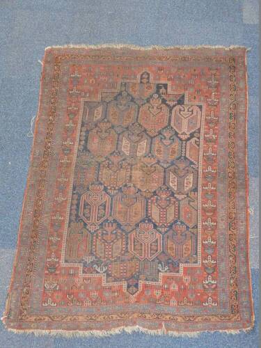 A Turkish design rug, with multi gul central field on a blue ground enclosed by a red border with guls within a triple border on a blue ground, 163cm x 118cm. (AF) Auctioneers Note: Rug has live moth, and all are as found. Viewing is strongly recommended