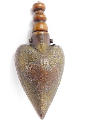 A 19thC Ottoman wooden and horn powder flask, with carved decoration and brass overlay, iron ring carrying handle, 28.5cm H.