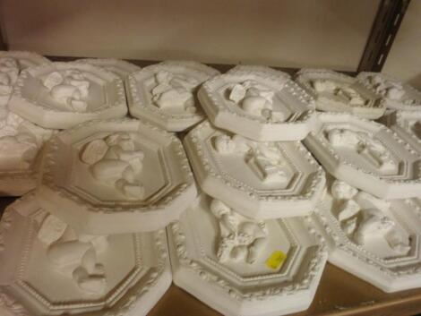 A large quantity of plaster putto plaques